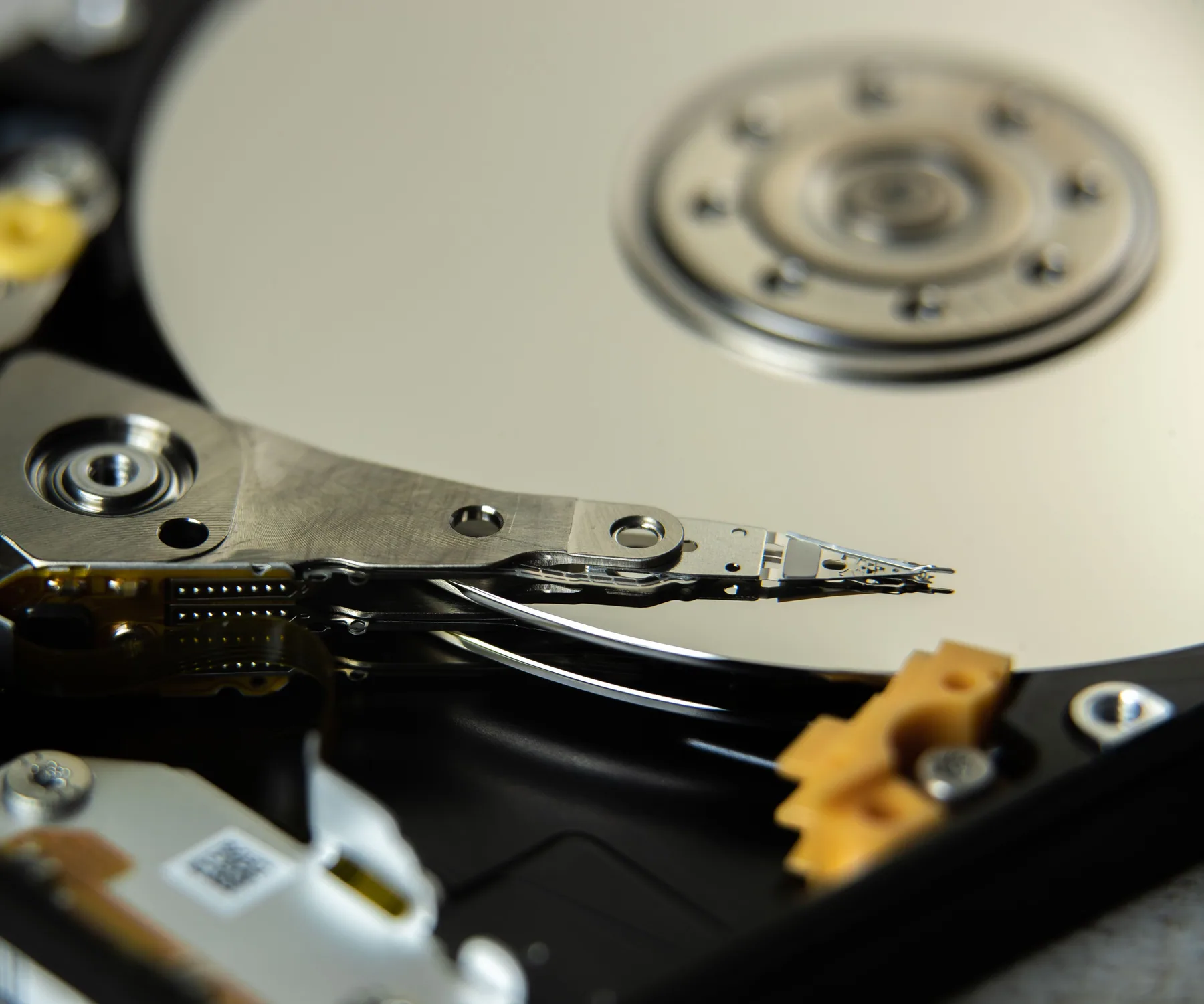 Close-up of the platter and actuator inside an open hard drive